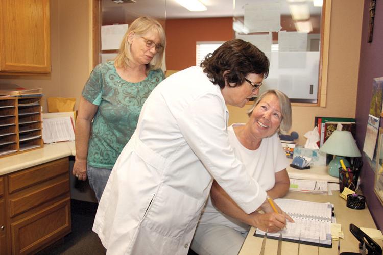Clinic staff working together at the front desk