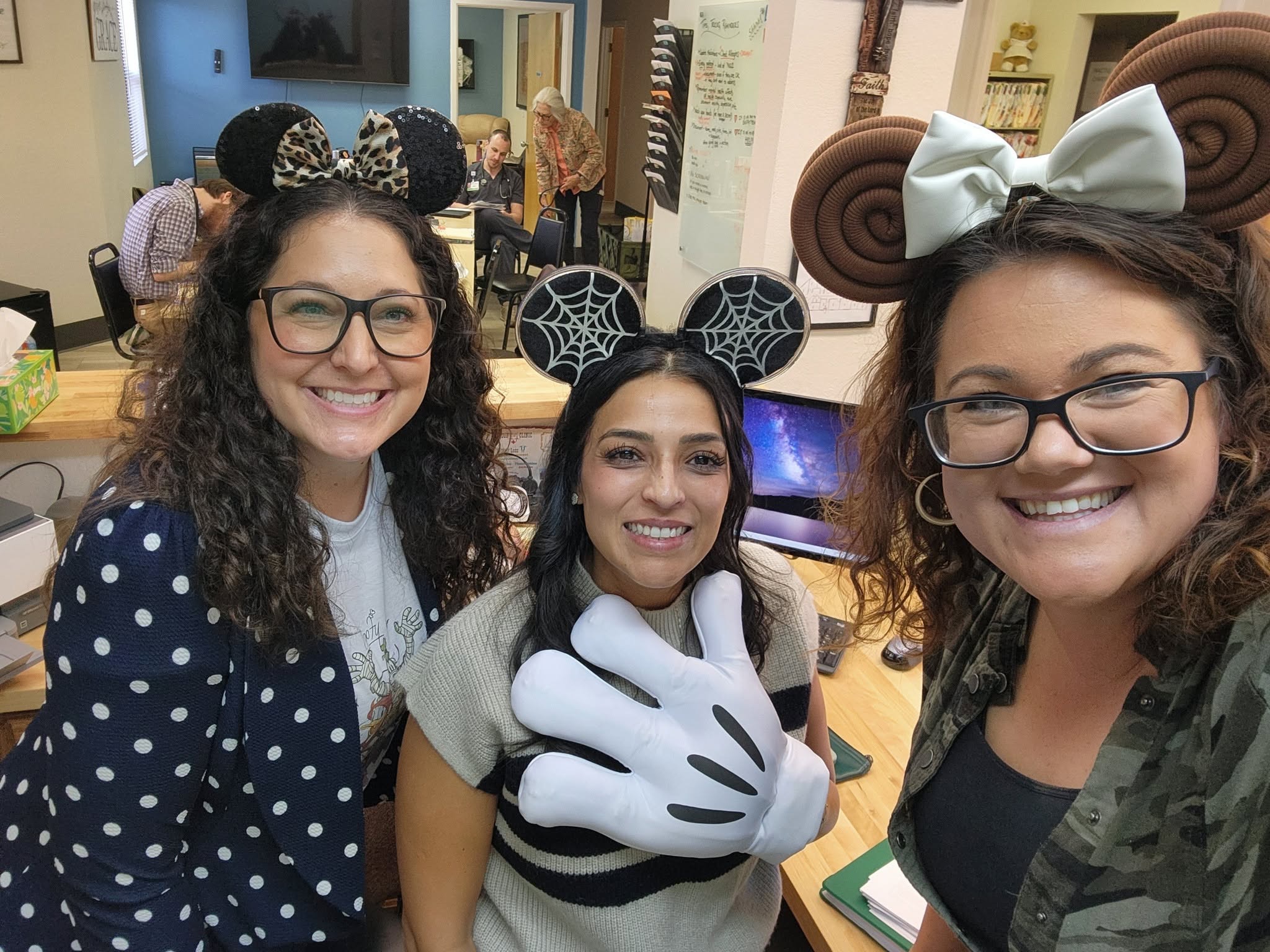 Clinic team members smiling together in playful costumes