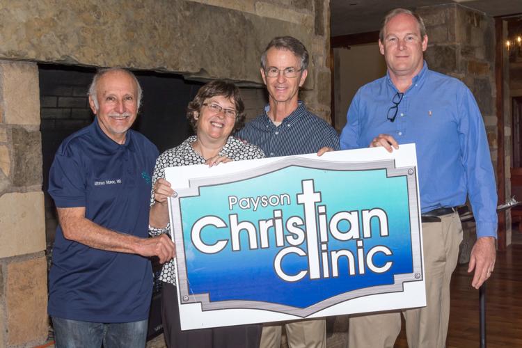 Clinic supporters holding a Payson Christian Clinic sign
