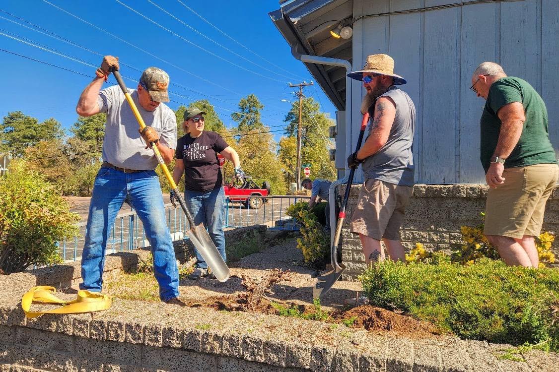 Volunteers landscaping outside the clinic building